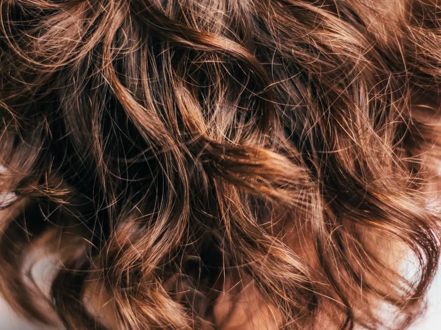 A close-up of wavy chestnut brown hair